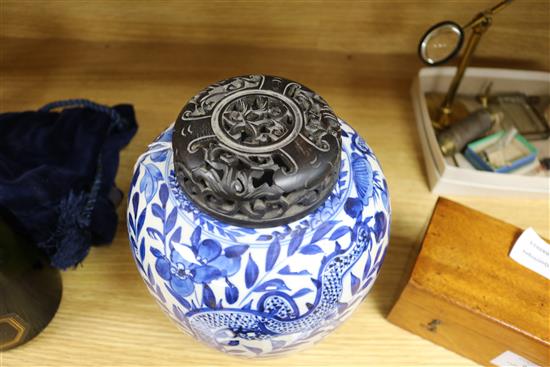 A Chinese blue and white jar, with hardwood cover height 22cm